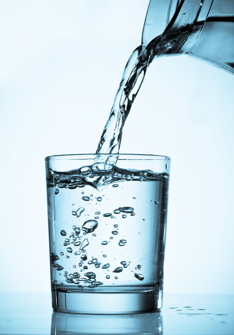 Clean water poured after being treated by Amber Water Pros carbon water filters.